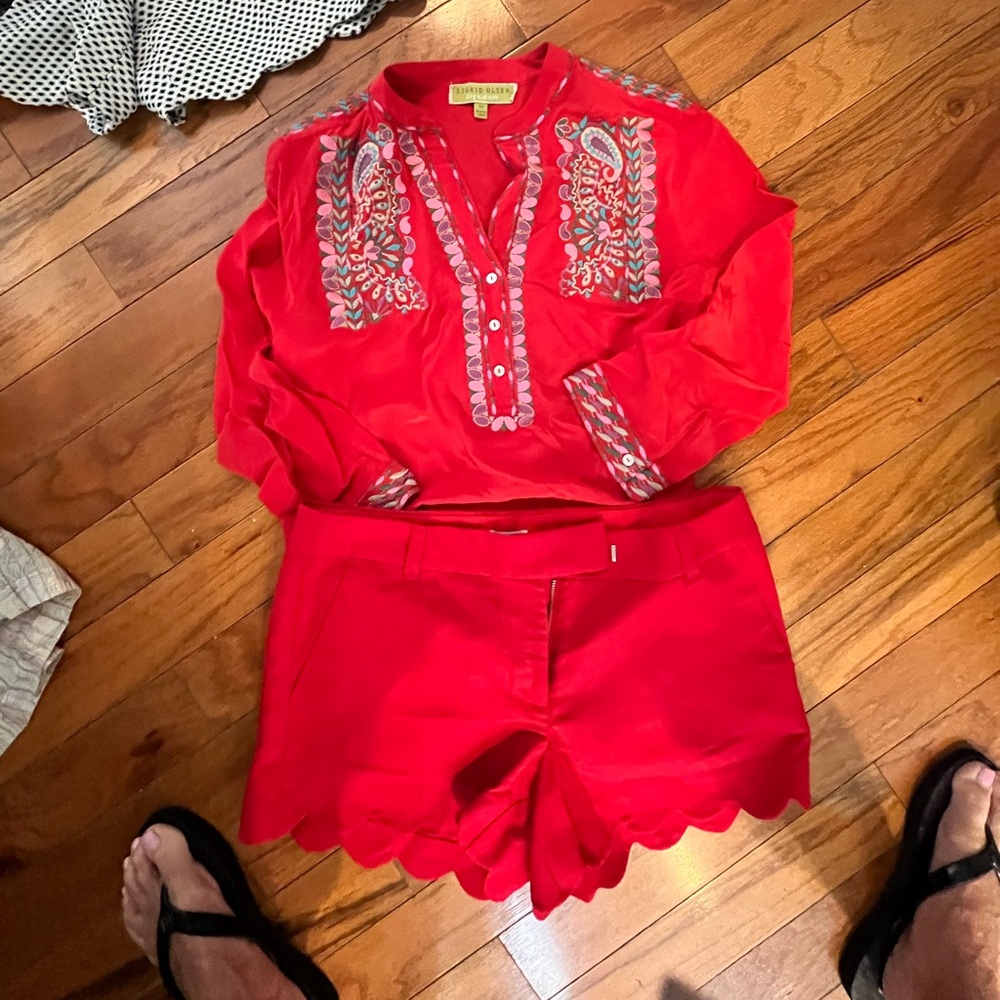 Red and pink top. Red shorts.